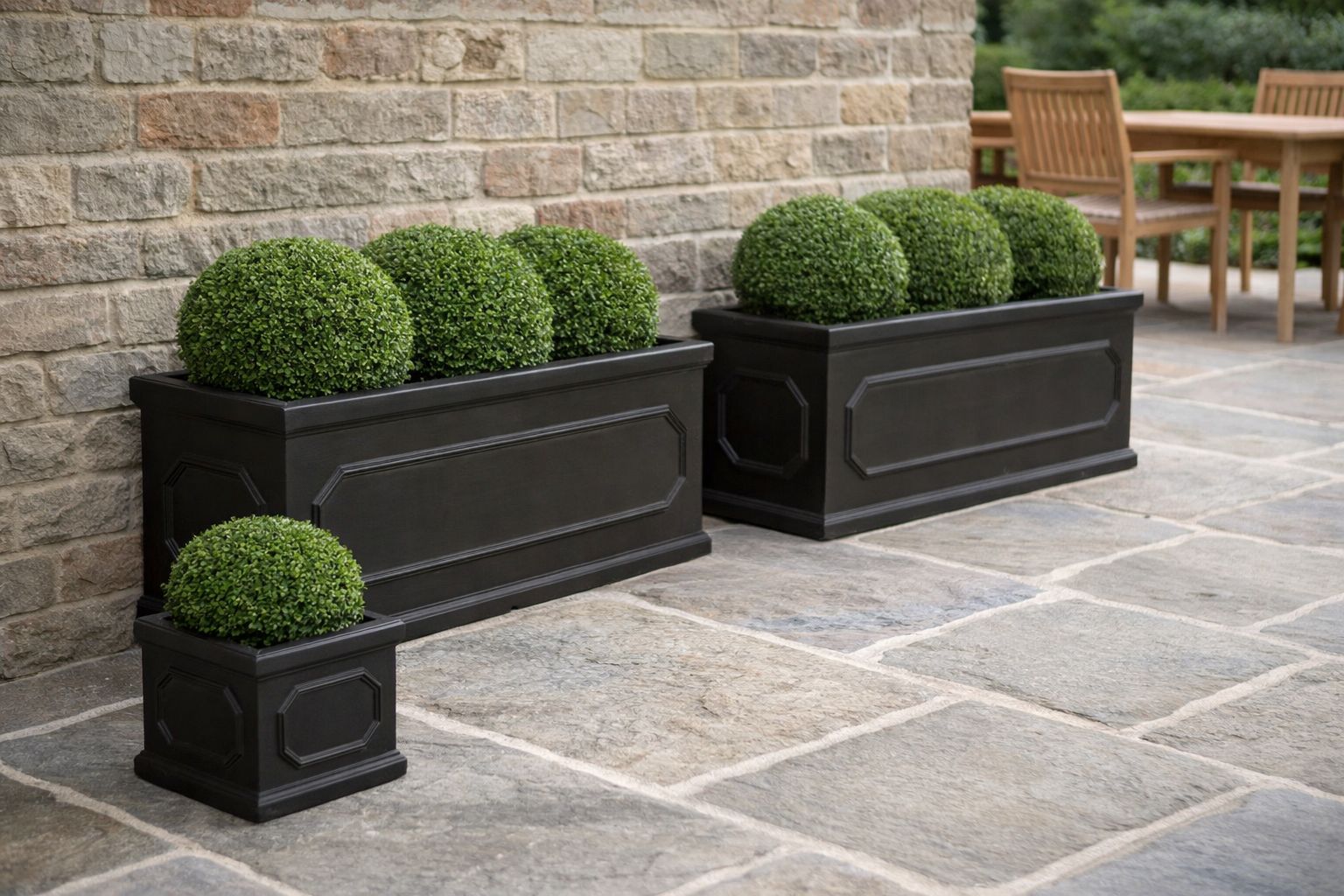 Large patio planters lining a garden terrace